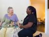 The Claiborne at Johns Creek senior living community staff member assisting a resident in her apartment