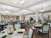 The Claiborne at Johns Creek senior living community amenity private dining room with dining table and chairs and upscale furnishings