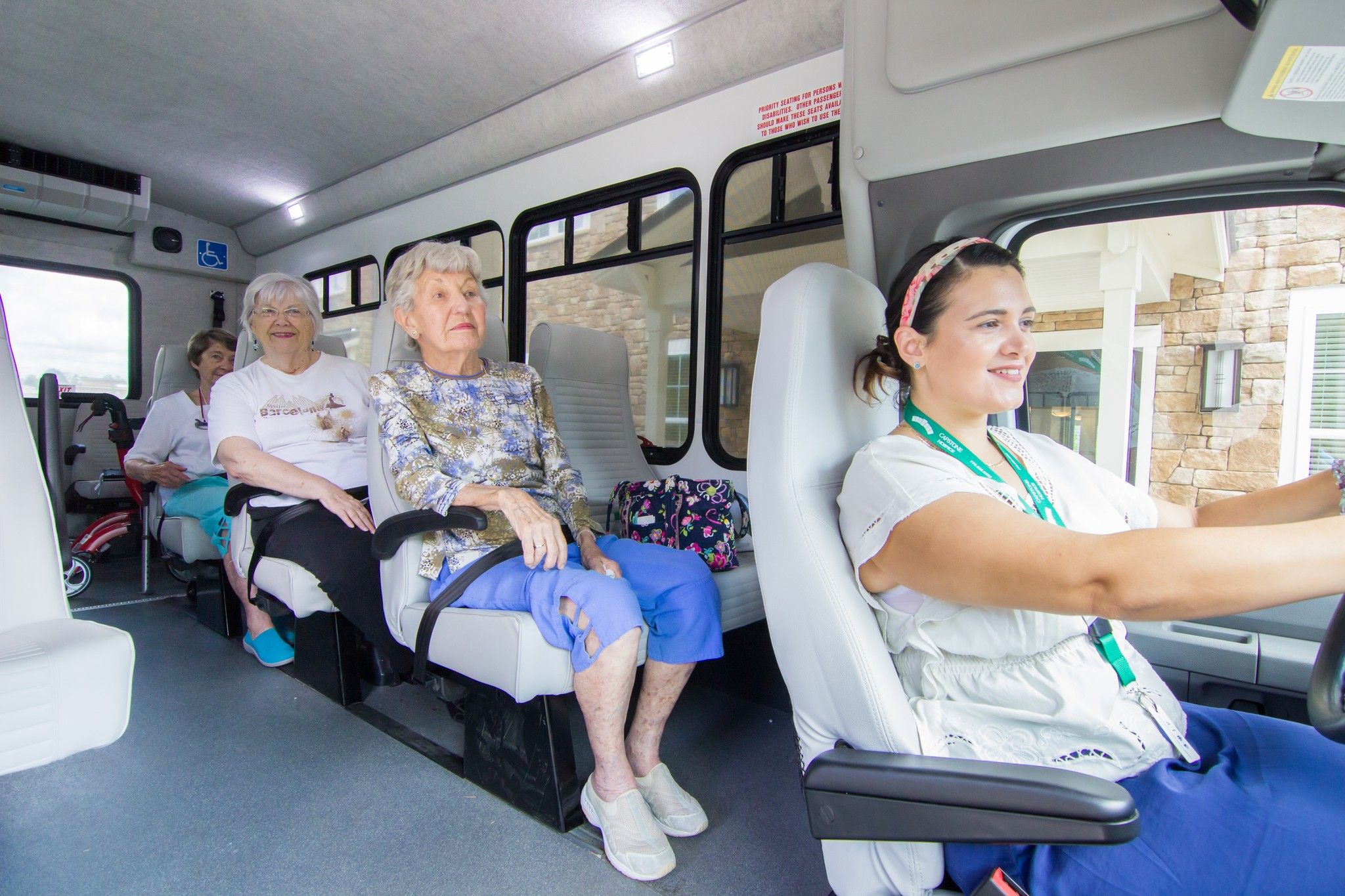 The Claiborne at Roswell senior citizen shuttle interior with bus driver