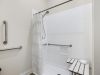 The Claiborne at Woodstock apartment bathroom with walk-in shower, accessible sink, and ample storage