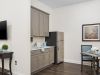 The Claiborne at Woodstock apartment bedroom with full sized bed, carpeting, and large windows