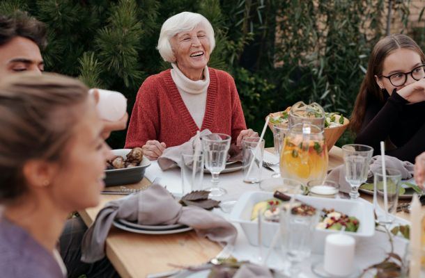 Senior women with family at the dinner table outdoors