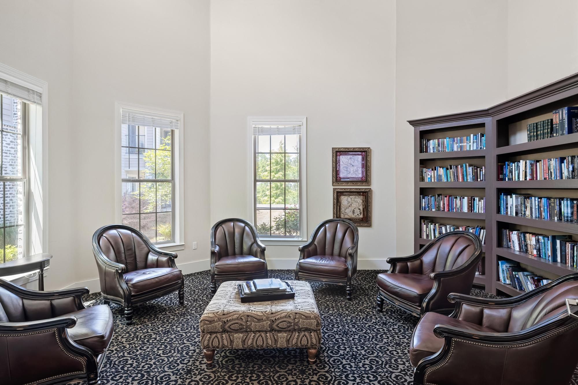 The Claiborne at Hattiesburg large library with seating and book shelves