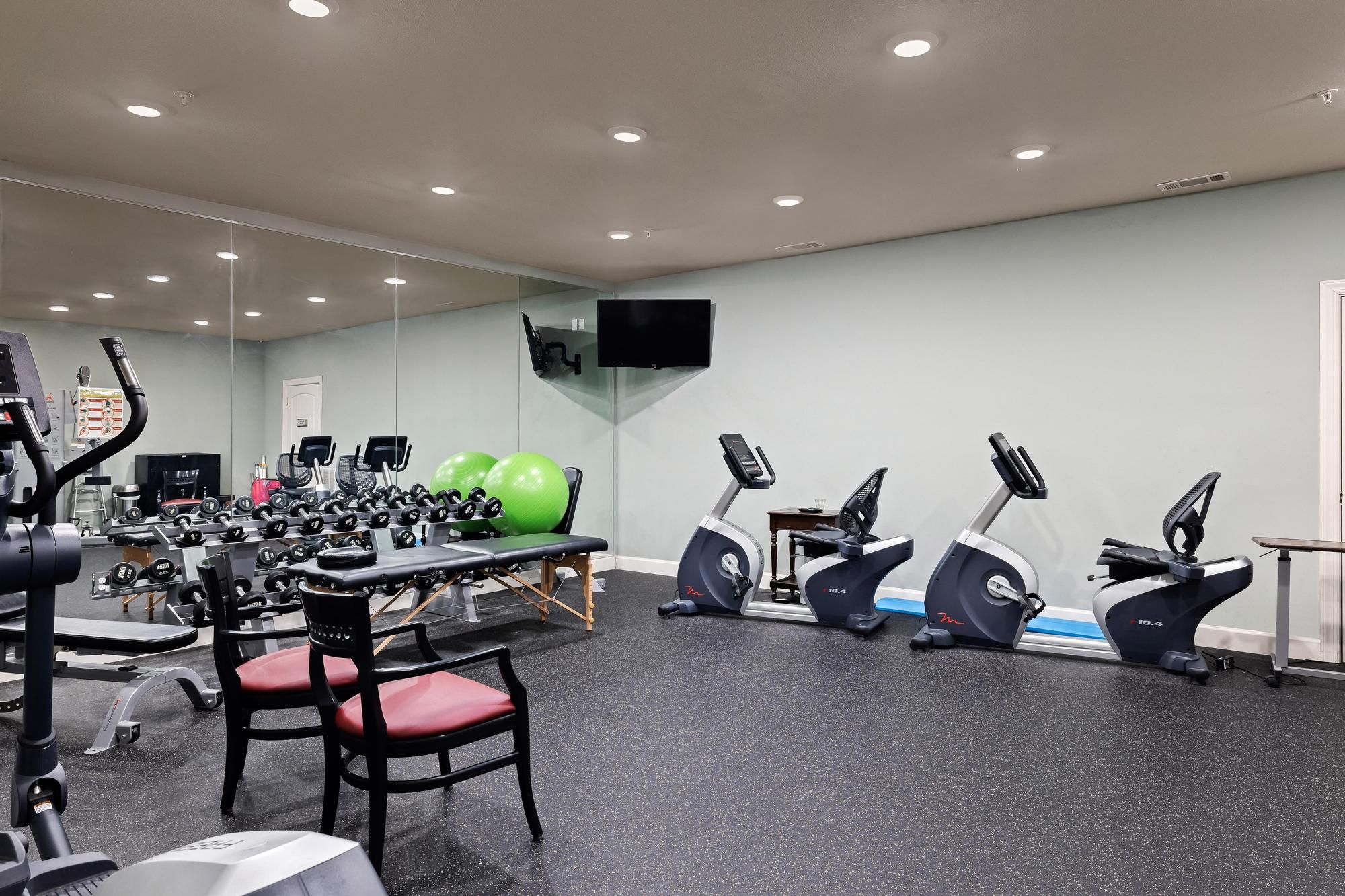 The Claiborne at Hattiesburg fitness center with free weights and cardio machines