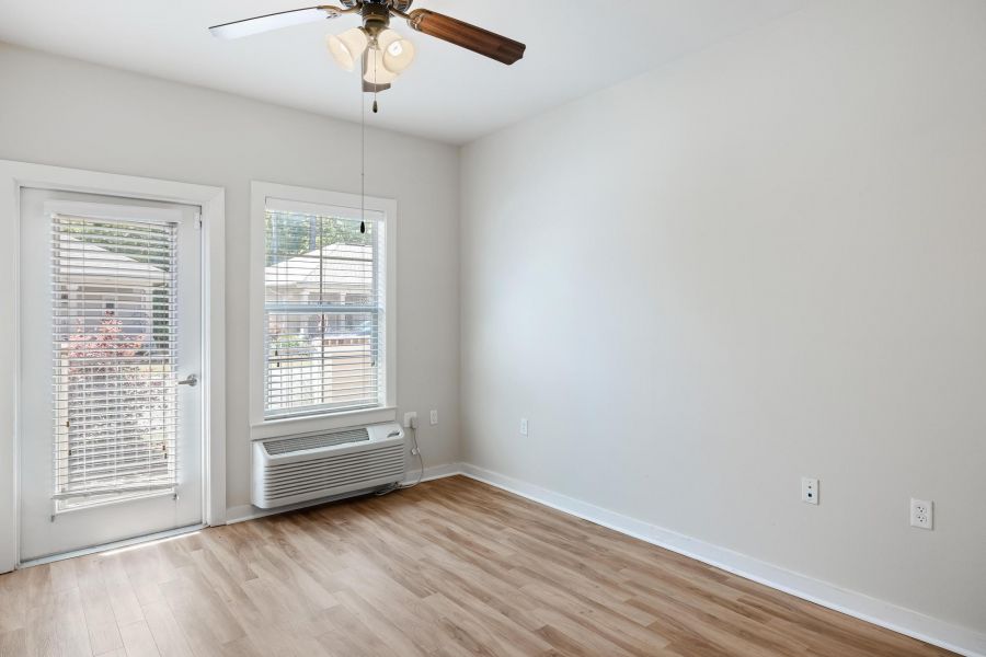 The Claiborne at Hattiesburg senior independent living cottage with open floor plan, direct exterior access, wood flooring, and ceiling fan