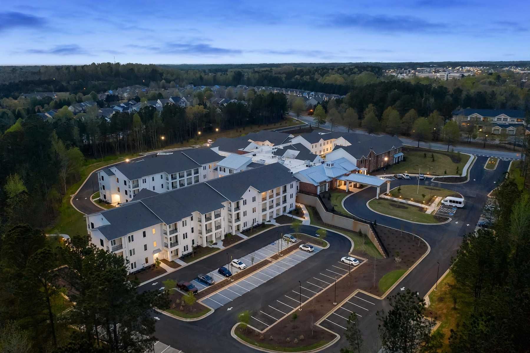 The Claiborne at Newnan Lakes aerial view of community showing wooded setting