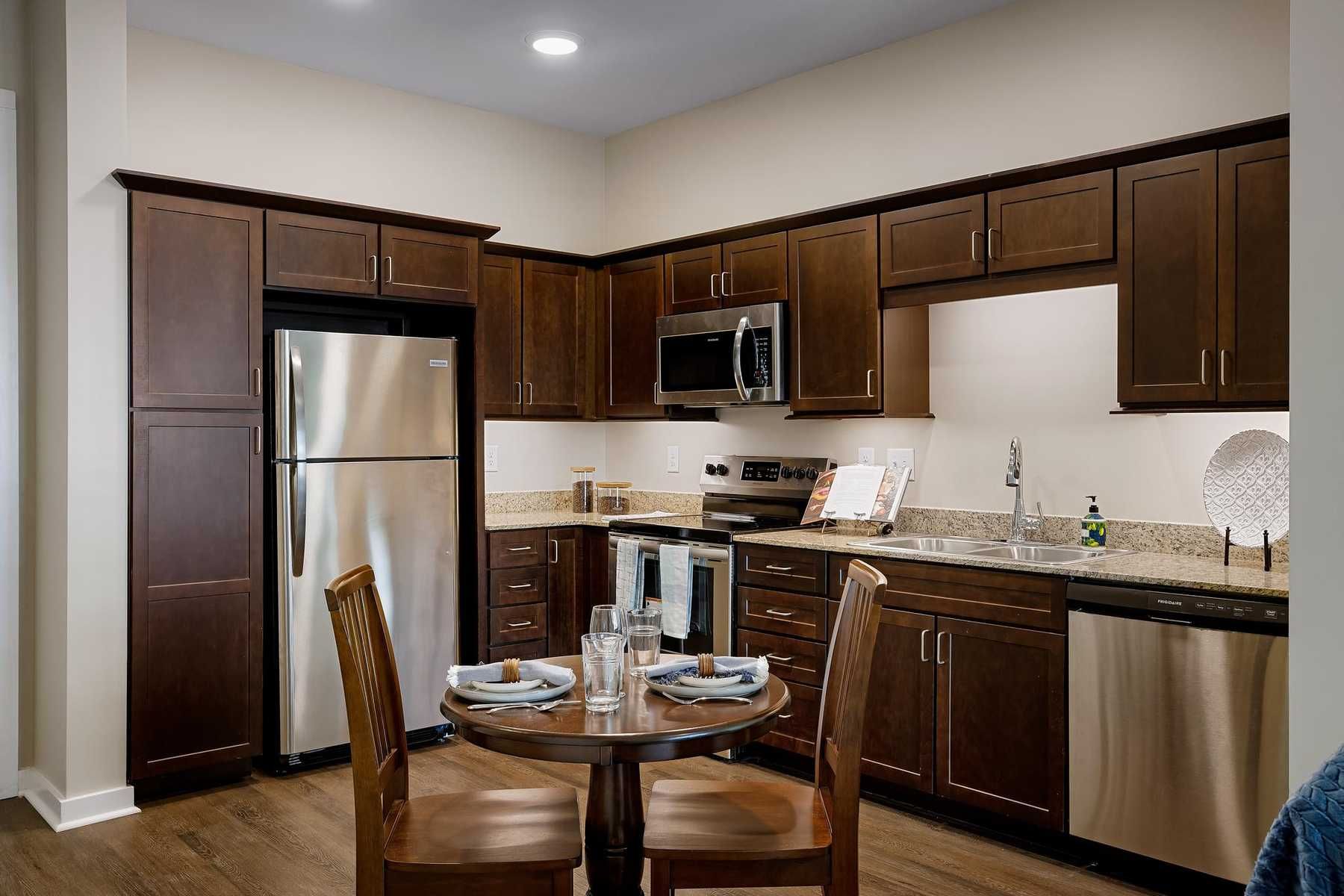 The Claiborne at Newnan Lakes senior apartment full kitchen with high-end design and appliances