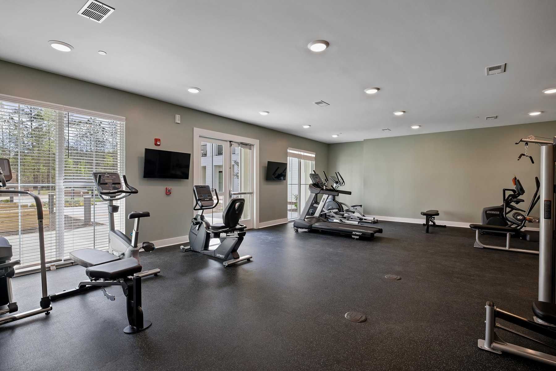 The Claiborne at Newnan Lakes gym with exercise equipment and on-site therapy services