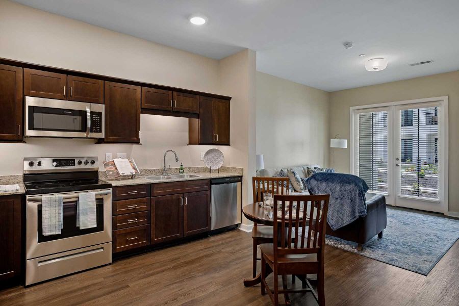 The Claiborne at Newnan Lakes senior living community full kitchen and living area