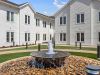 The Claiborne at Newnan Lakes outdoor courtyard with fountain and walking paths