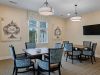 The Claiborne at Newnan Lakes game room with tables and chairs