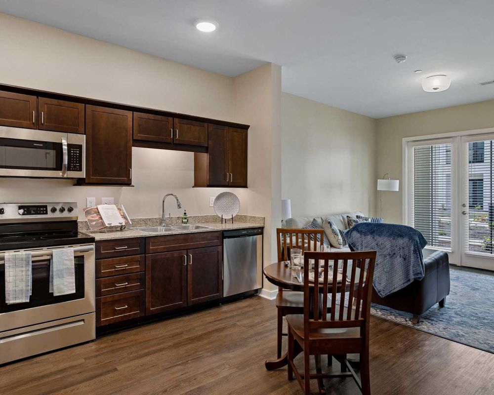 The Claiborne at Newnan Lakes senior living community full kitchen and living area
