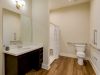 The Preserve at Meridiansenior apartment accessible bathroom with handrails, wheelchair accessible sink, and zero-entry shower