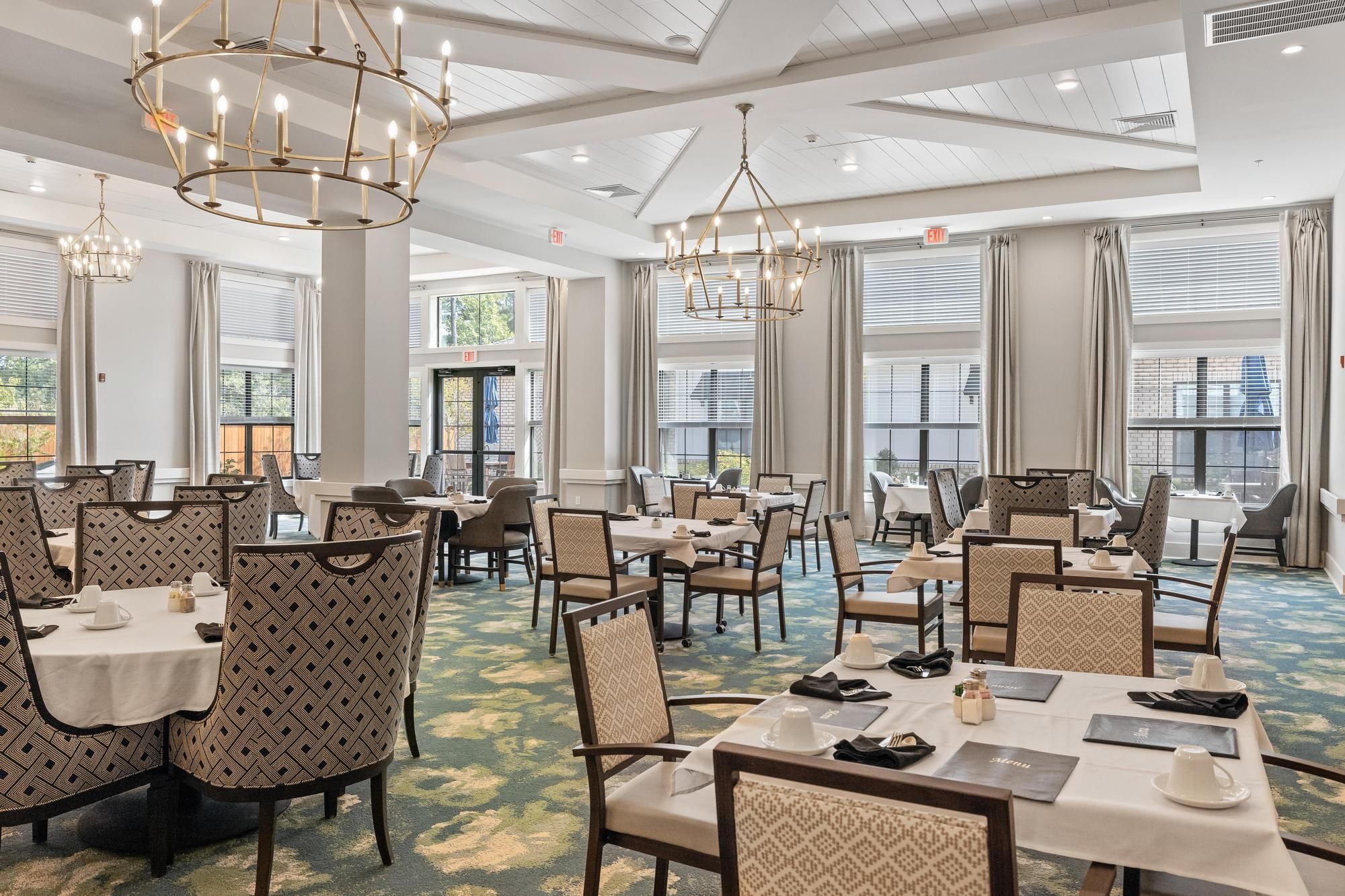 The Preserve at Meridian dining area with fireplace, tables, and chandeliers