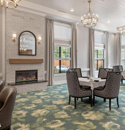 The Preserve at Meridian senior living community bar and bistro seating area with pendant lights and comfy chairs