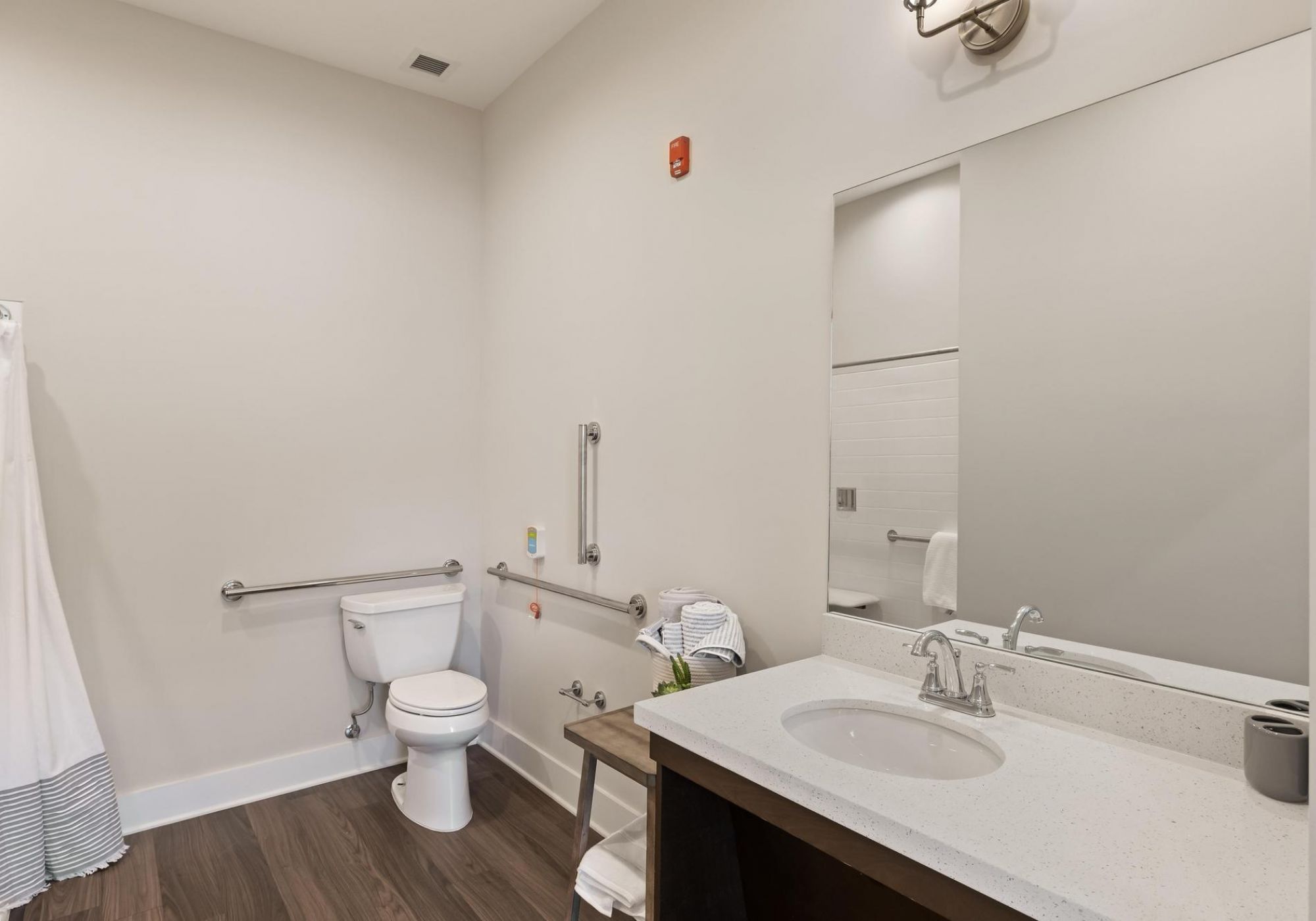 The Preserve at Meridian senior living bathroom showing accessibility features including handrails, lower sink height, and zero-entry shower