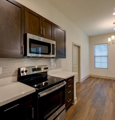 The Preserve at Meridian senior apartment full kitchen with stainless steel appliances and high-end finishes