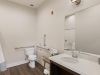 The Preserve at Meridiansenior apartment accessible bathroom with handrails, wheelchair accessible sink, and zero-entry shower