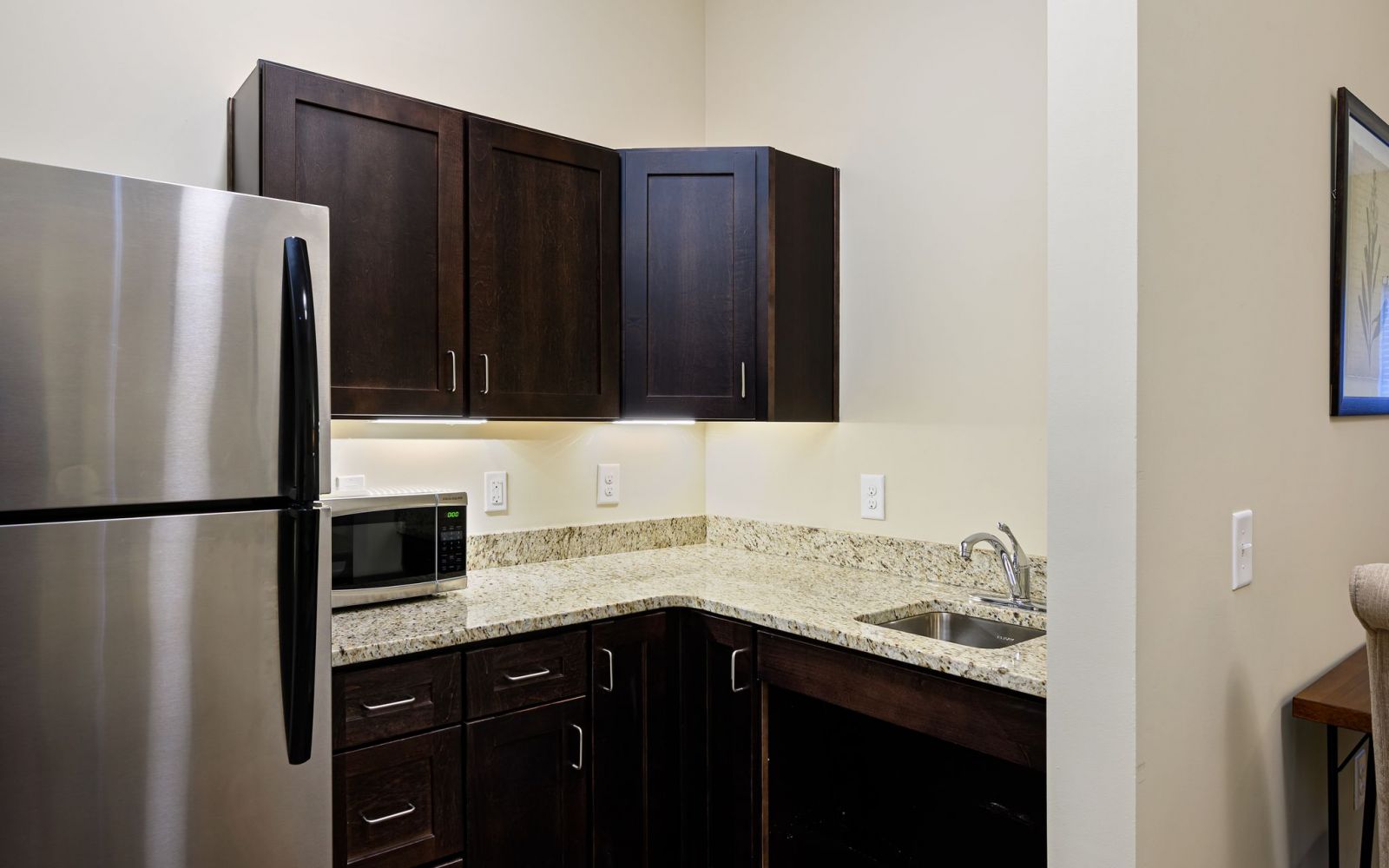 The Claiborne at Shoe Creek assisted living kitchenette showing accessibility features including sink and cabinet height