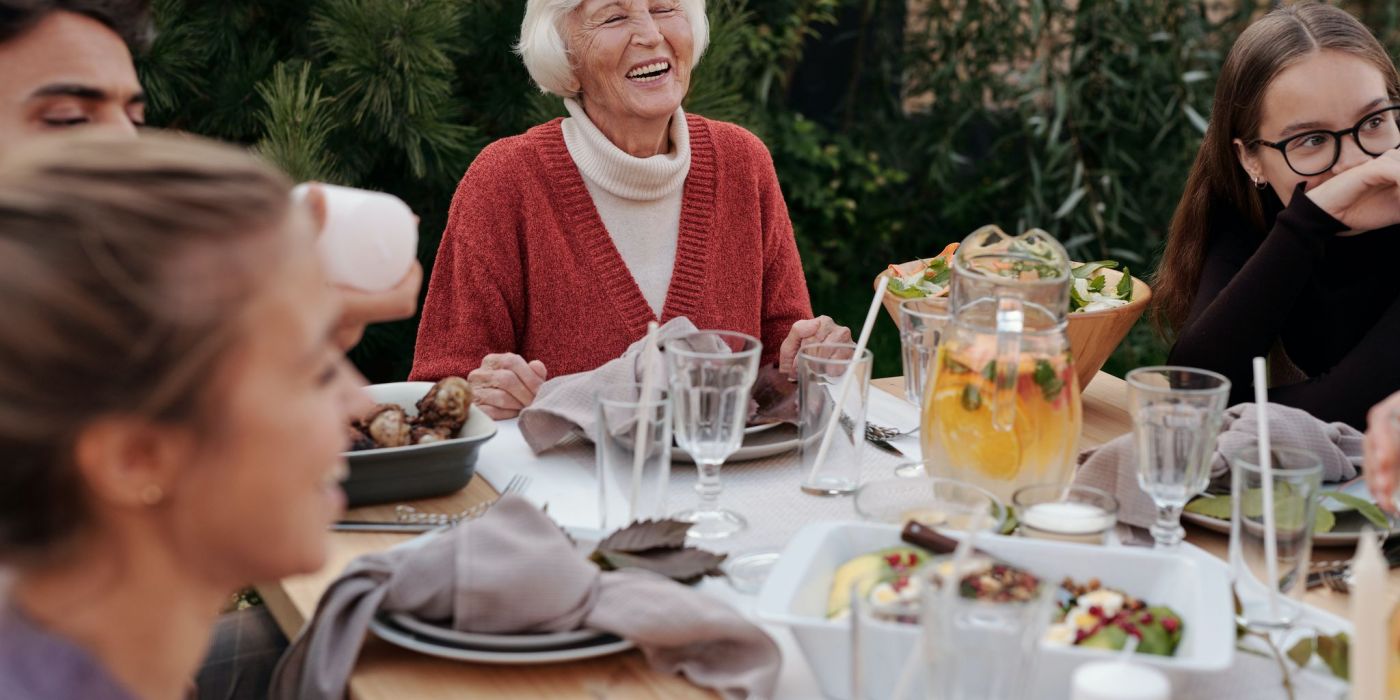 Senior women with family at the dinner table outdoors