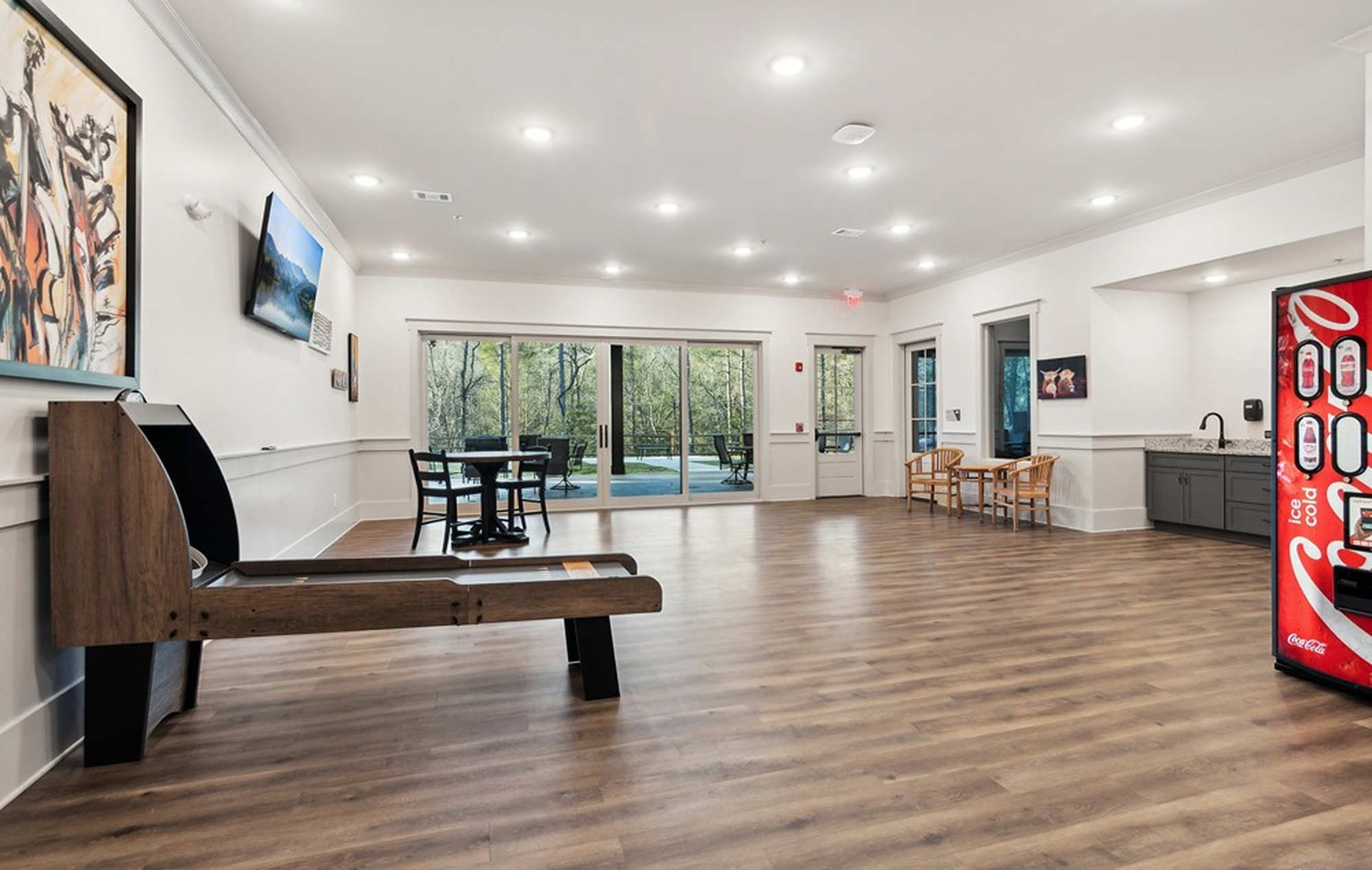 The Timbers on Blackwell Creek activity room with a shuffleboard table and seating