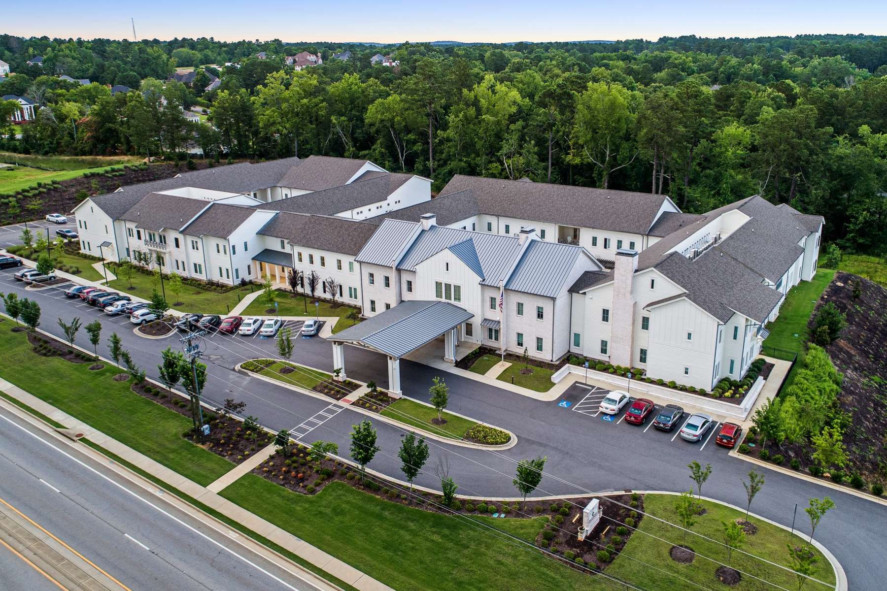 The Claiborne at West Lake aerial view of community and location with backdrop being a wooded setting