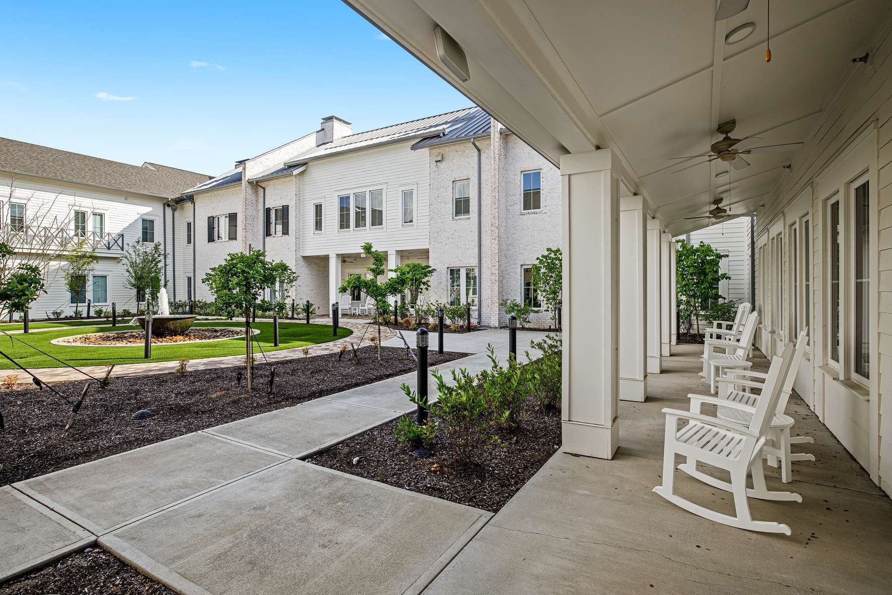 The Claiborne at West Lake courtyard view with rocking chairs