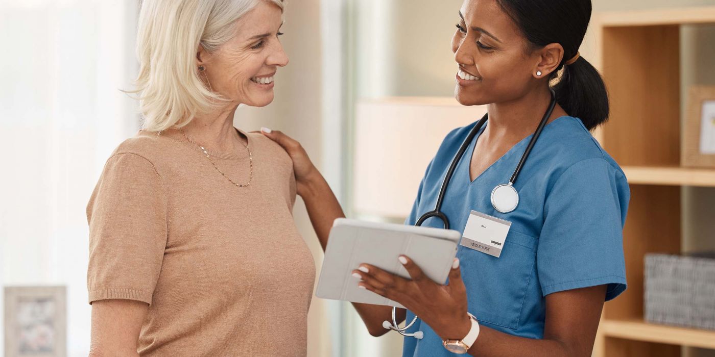 Shot of a doctor using a digital tablet during a consultation with a senior woman.