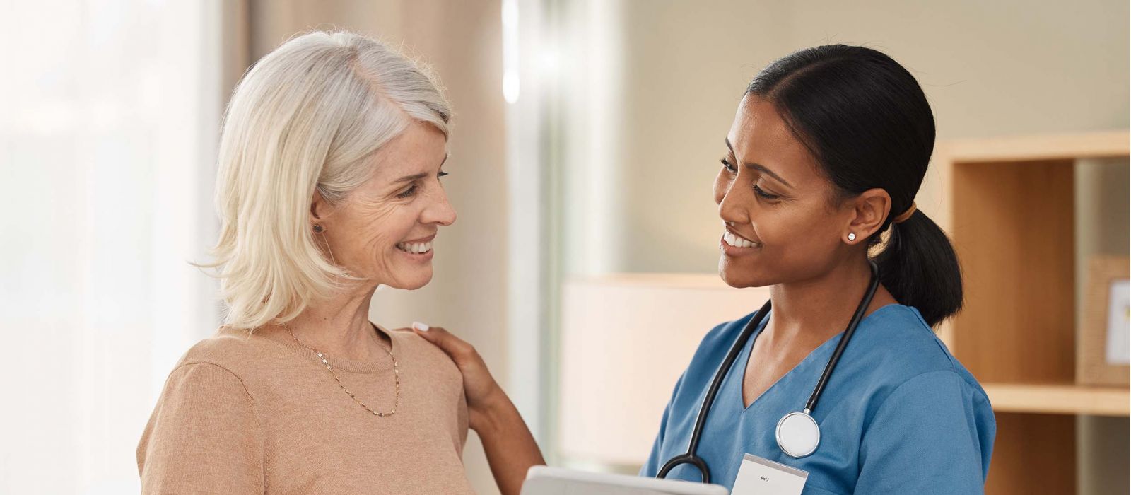 Shot of a doctor using a digital tablet during a consultation with a senior woman.