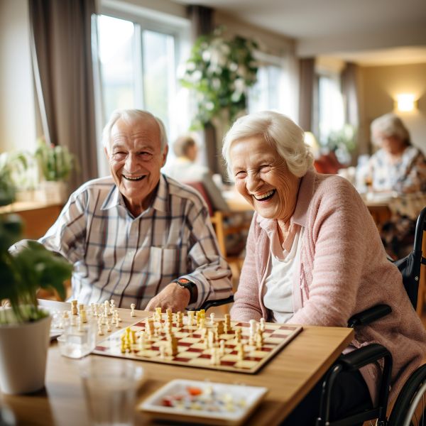 Cute senior couple playing chess in senior living community