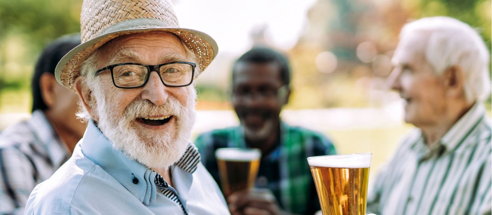 Group of senior men drinking beer in a park