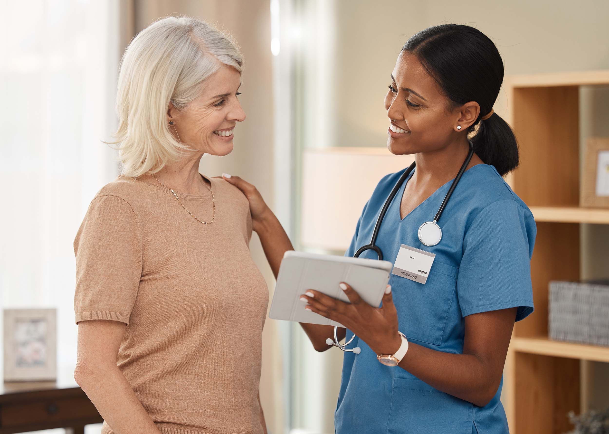 Shot of a doctor using a digital tablet during a consultation with a senior woman.