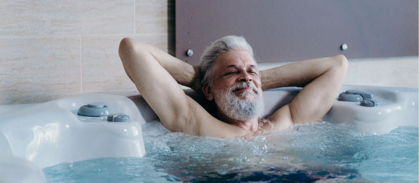 Senior man in a hot tub.