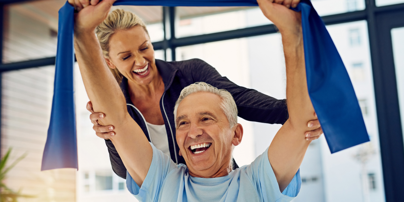 Senior man performing arm exercises with a physical therapist