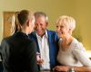 Elderly guests check in at a retirement home on a tour