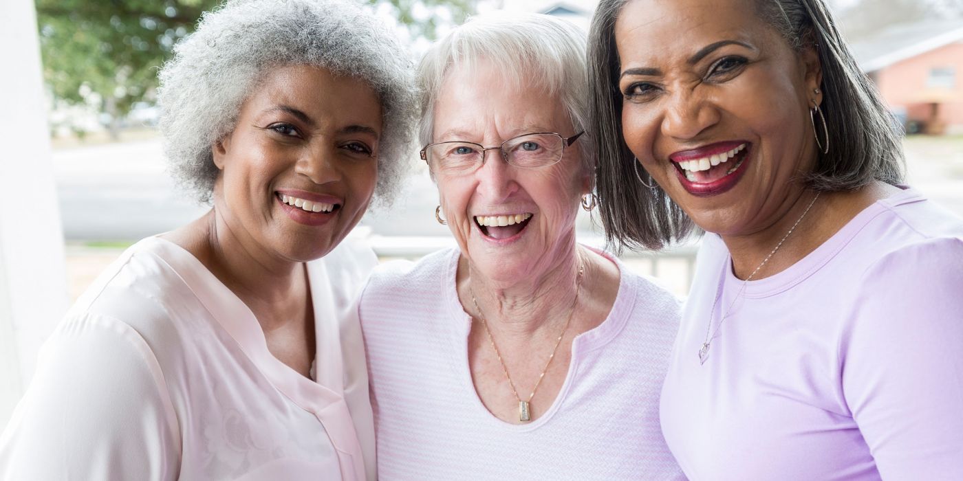 Three senior girlfriends smiling together