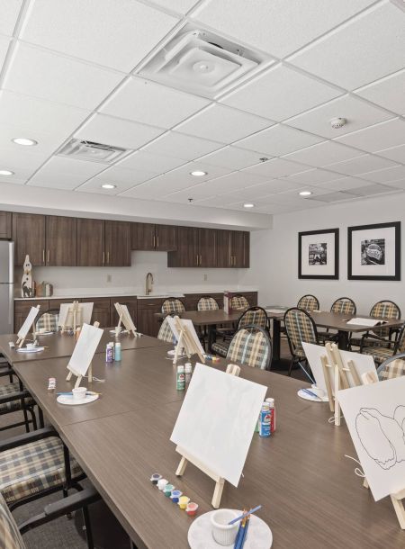 The Avaline at River Oak activity room with large table with painting canvases.