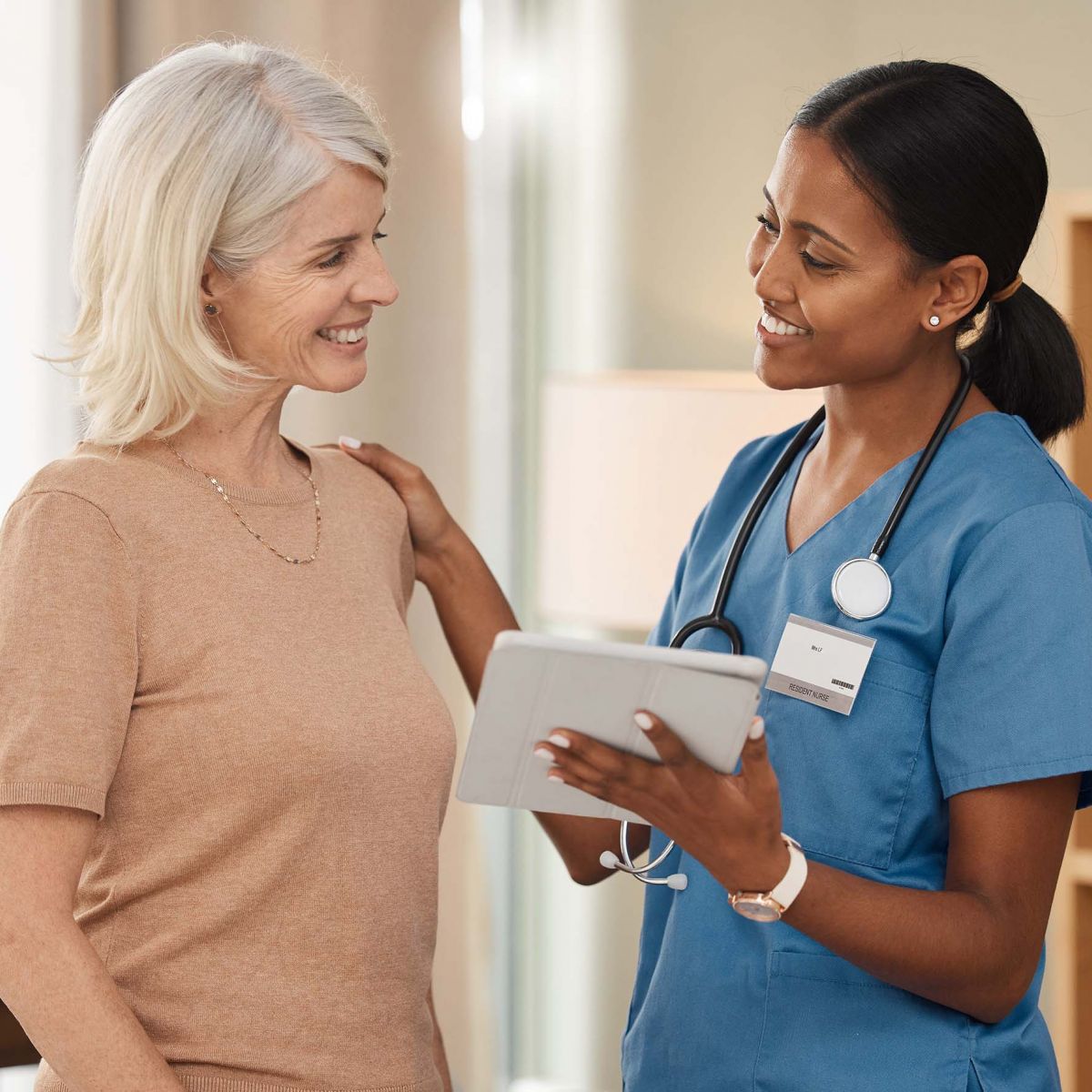 Shot of a doctor using a digital tablet during a consultation with a senior woman.