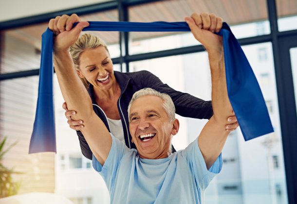 Senior man performing arm exercises with a physical therapist