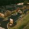 Aerial exterior view of Brickmont at Acworth with numerous parking spaces surrounded by greenery and trees.