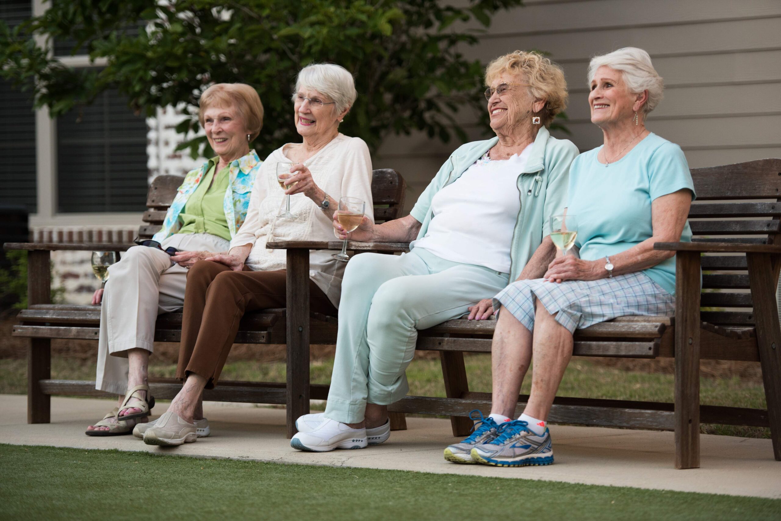 senior women relaxing and talking outside on a bench