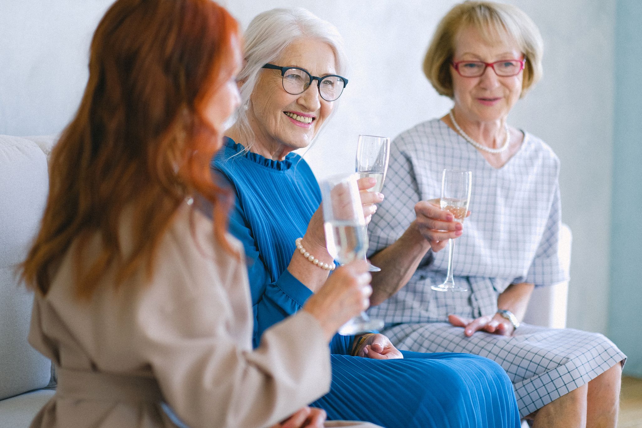 Senior women celebrating with champagne.