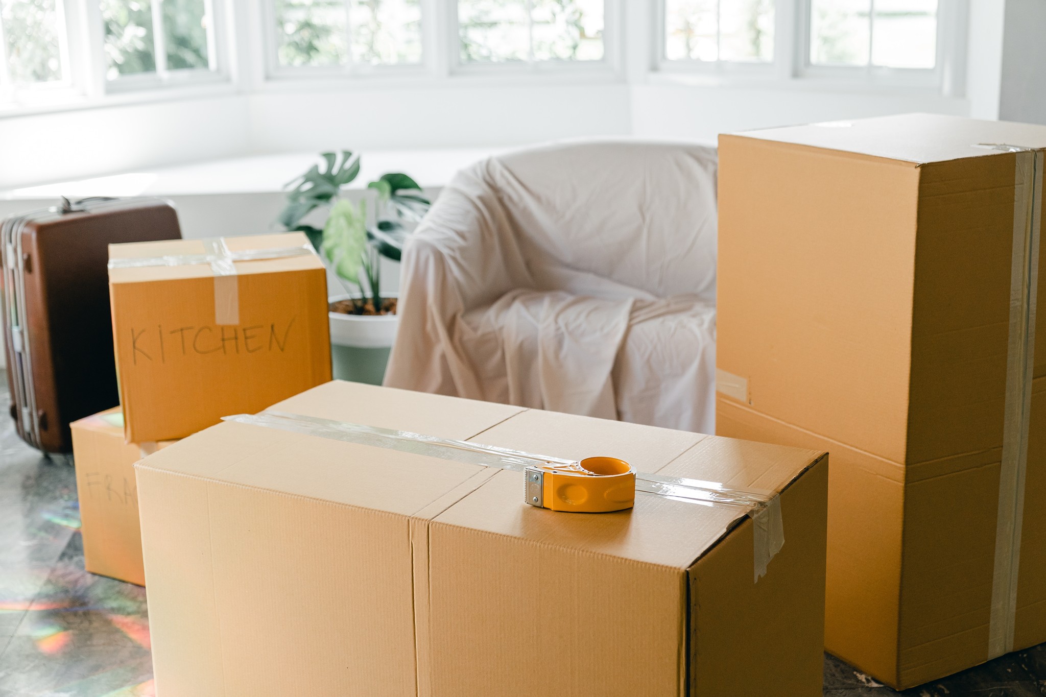 Moving Boxes and Covered Furniture in a bright room