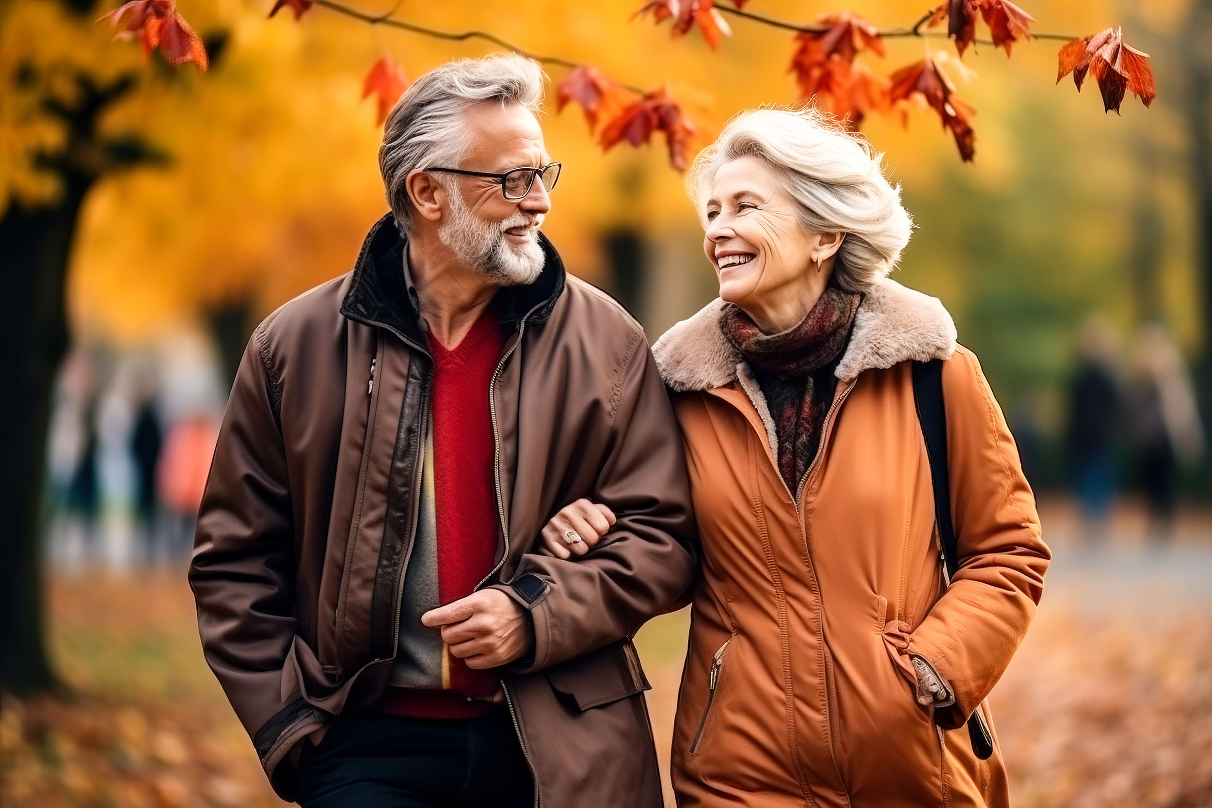 Beautiful elderly couple walking in an autumn park